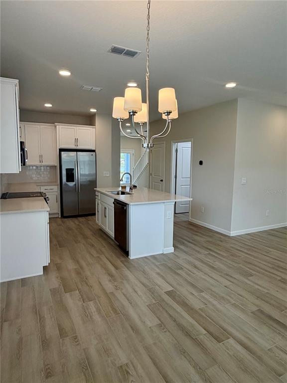 5222 Ctr Lk Rnch Boulevard St. Cloud, FL 34771 - Photo 4 of 25 a kitchen with stainless steel appliances granite countertop a wooden floors and large cabinets
