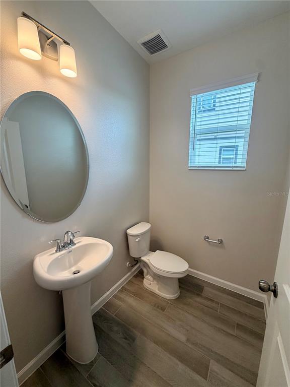 5222 Ctr Lk Rnch Boulevard St. Cloud, FL 34771 - Photo 5 of 25 a bathroom with a sink toilet and a mirror
