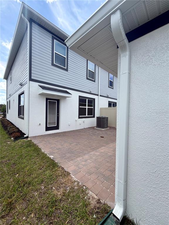 5222 Ctr Lk Rnch Boulevard St. Cloud, FL 34771 - Photo 6 of 25 a view of a house with a backyard and a garage