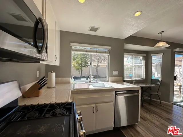 a kitchen with a sink stove and cabinets