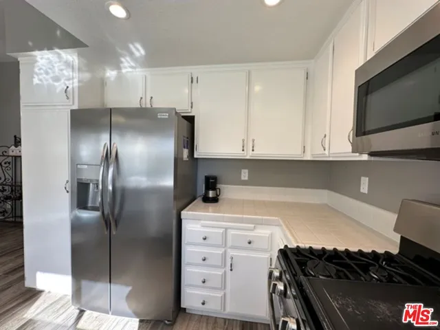 a kitchen with cabinets and steel stainless steel appliances