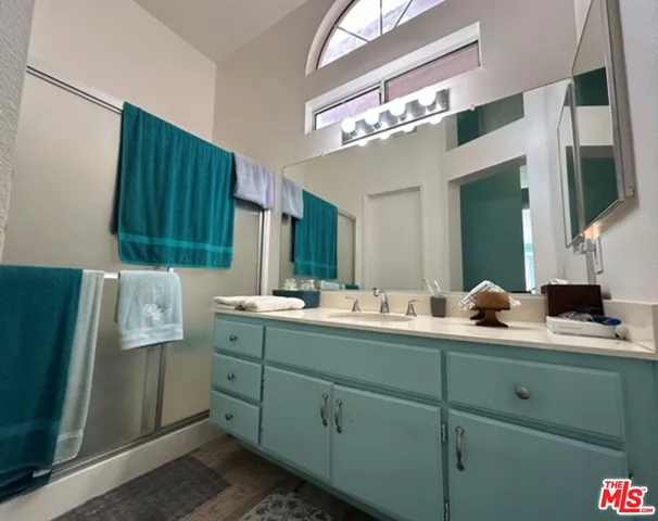 a bathroom with a double vanity sink and mirror