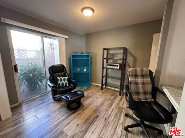 a view of a workspace with furniture and a window
