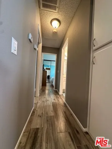 a view of hallway with wooden floor