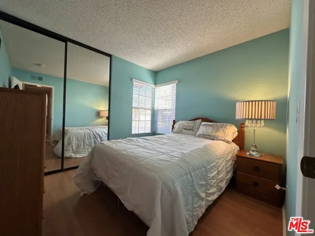 a bedroom with a bed and a mirror