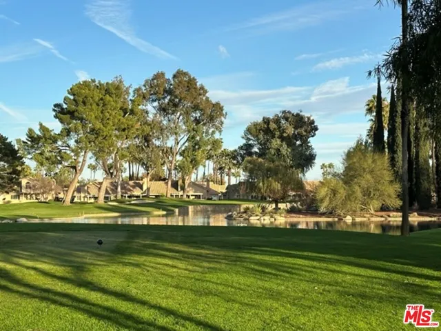 a view of a house with yard and sitting area