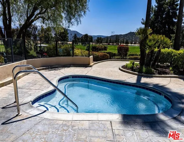 a view of a swimming pool with outdoor seating and yard