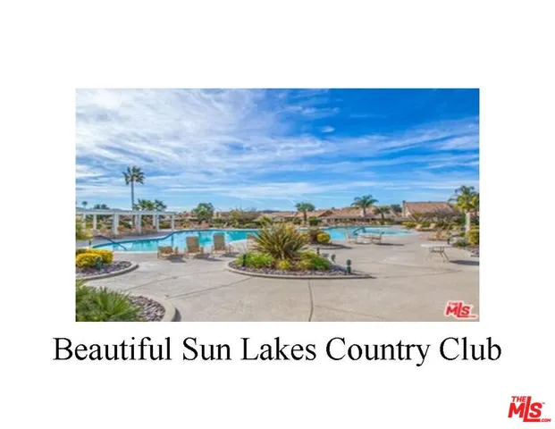 a view of a swimming pool with a table and chairs