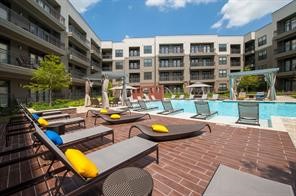 2033 South Gessner Road, Unit 3220 Houston, TX 77063 - Photo 13 of 20 a view of a swimming pool with a patio and plants