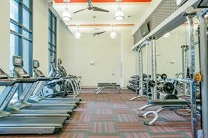 2033 South Gessner Road, Unit 3220 Houston, TX 77063 - Photo 17 of 20 a view of living room filled with furniture and floor to ceiling window