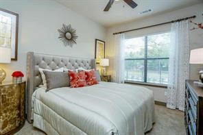 2033 South Gessner Road, Unit 3220 Houston, TX 77063 - Photo 4 of 20 a bedroom with a bed and a chandelier