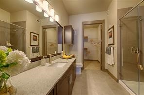 2033 South Gessner Road, Unit 3220 Houston, TX 77063 - Photo 5 of 20 a en suite bathroom with a granite countertop sink and a mirror