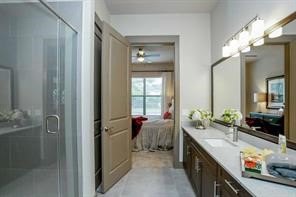 2033 South Gessner Road, Unit 3220 Houston, TX 77063 - Photo 6 of 20 a en suite bathroom with a double vanity sink a large mirror and a shower