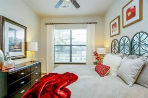 2033 South Gessner Road, Unit 3220 Houston, TX 77063 - Photo 7 of 20 a bedroom with a bed and wooden floor