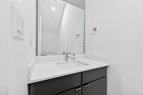 a bathroom with a sink a mirror and a vanity