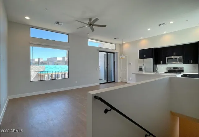 a kitchen with stainless steel appliances a refrigerator sink and microwave