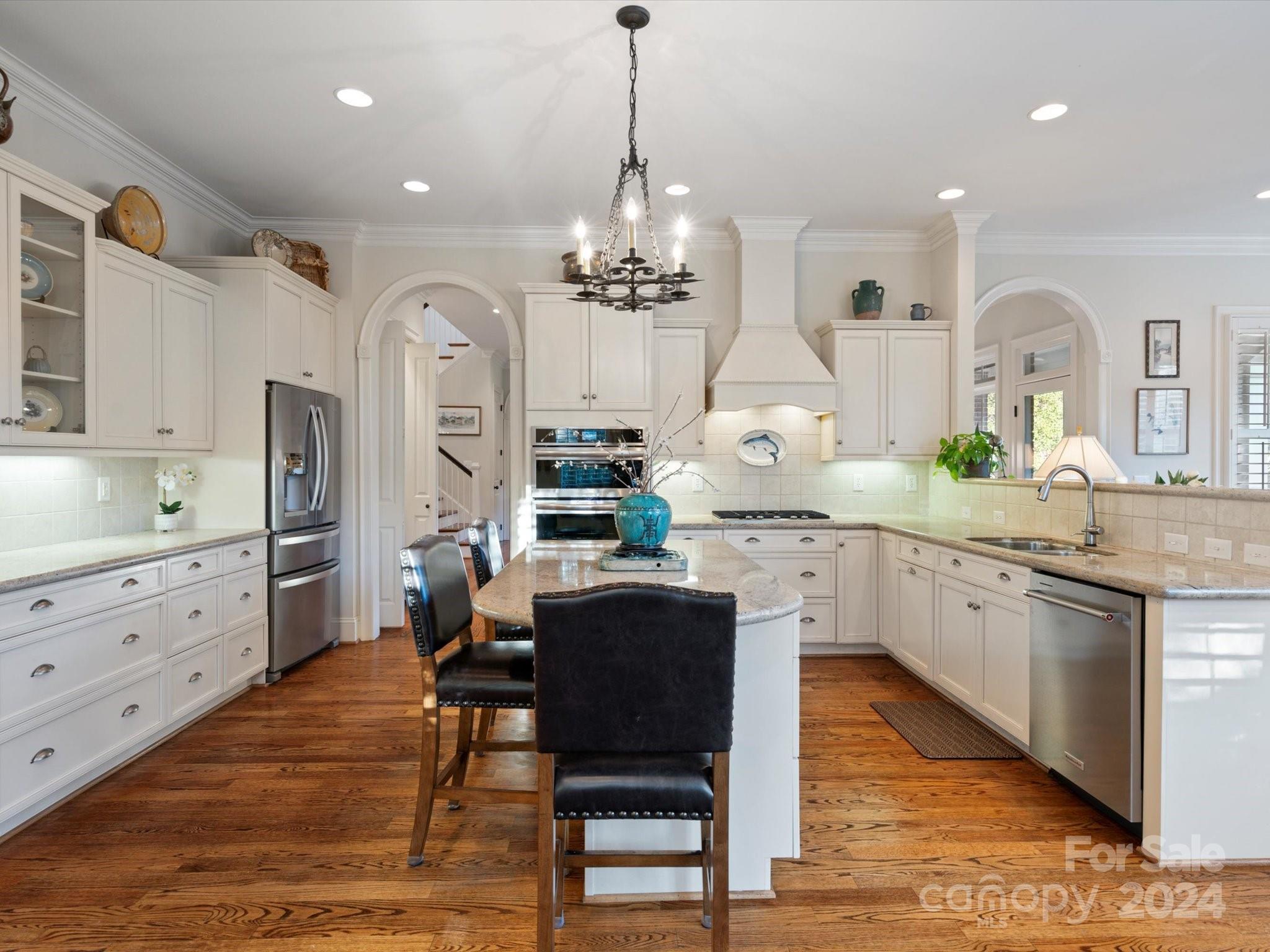135 Spring Branch Road Fort Mill, SC 29715 - Photo 15 of 48 a large kitchen with granite countertop a stove a sink a dining table and chairs