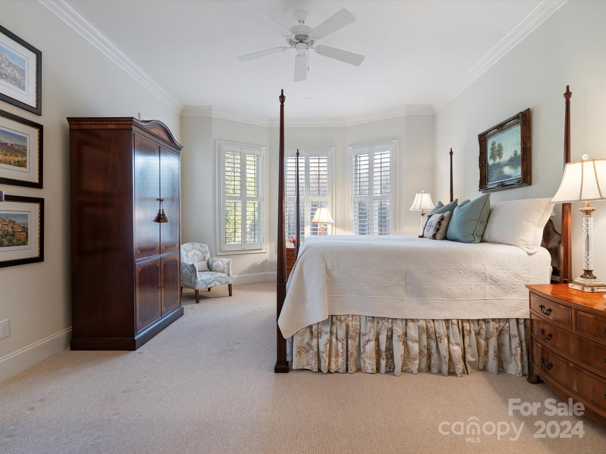 135 Spring Branch Road Fort Mill, SC 29715 - Photo 28 of 48 a bedroom with a large bed and a chandelier