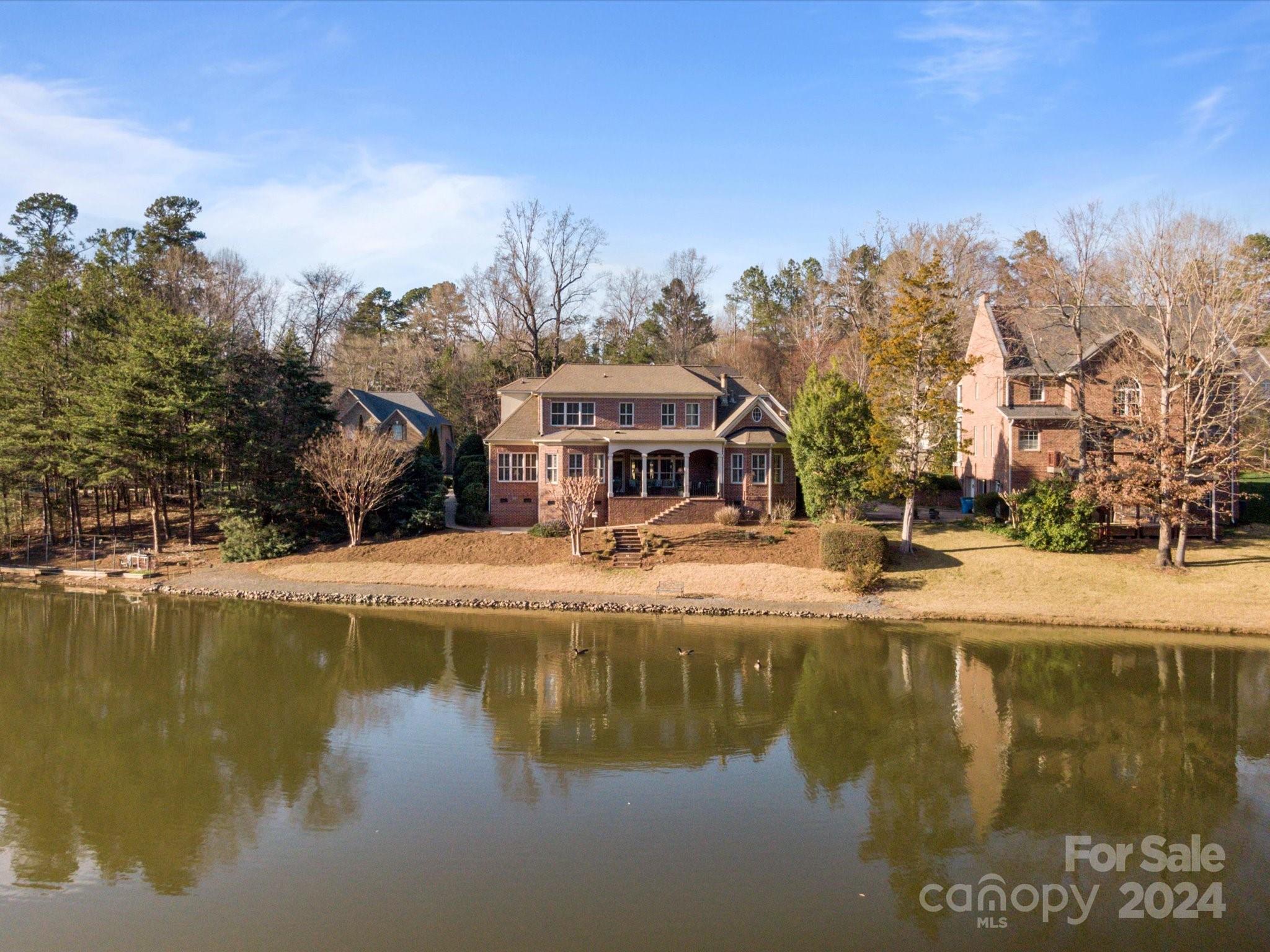 135 Spring Branch Road Fort Mill, SC 29715 - Photo 48 of 48 a view of a lake with a building in the background