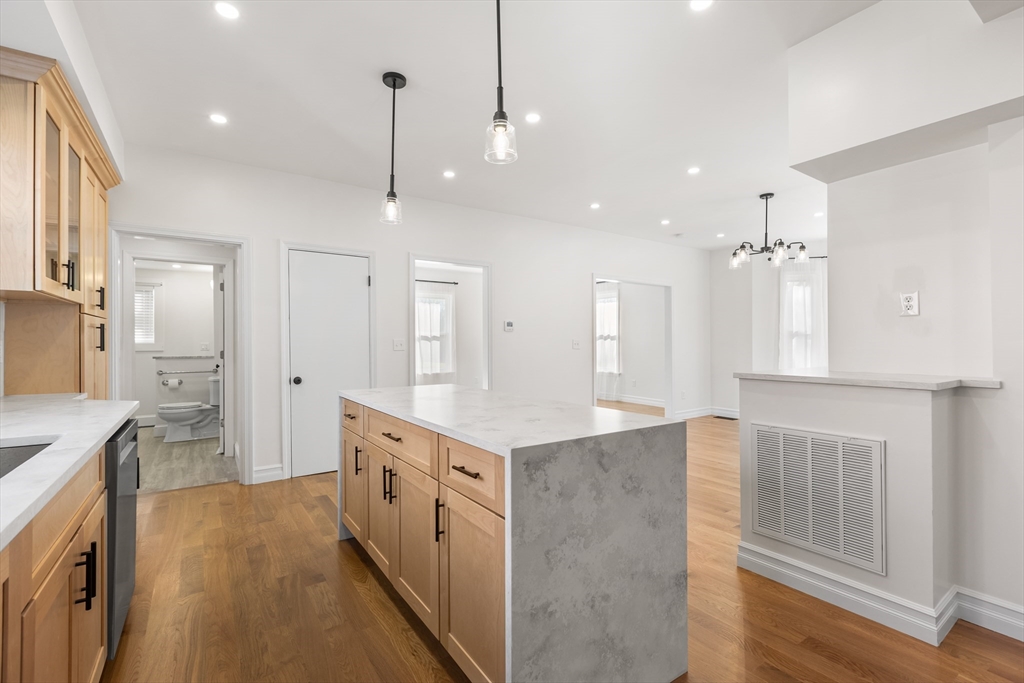 12 Viden Road Quincy, MA 02169 - Photo 13 of 29 a kitchen with kitchen island a stove a refrigerator a sink dishwasher with a dining table and chairs