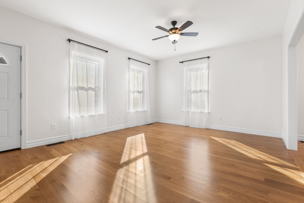 12 Viden Road Quincy, MA 02169 - Photo 16 of 29 a view of an empty room with a window and wooden floor