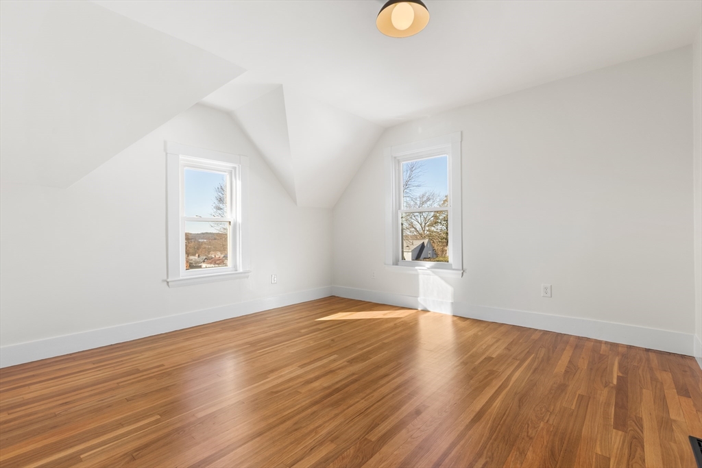 12 Viden Road Quincy, MA 02169 - Photo 18 of 29 an empty room with wooden floor and windows