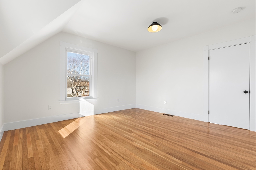 12 Viden Road Quincy, MA 02169 - Photo 19 of 29 a view of empty room with wooden floor and fan