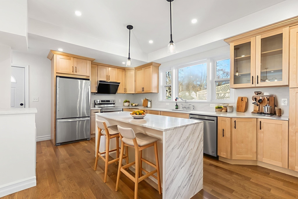 12 Viden Road Quincy, MA 02169 - Photo 3 of 29 a kitchen with stainless steel appliances granite countertop a refrigerator a sink dishwasher a stove and white cabinets with wooden floor