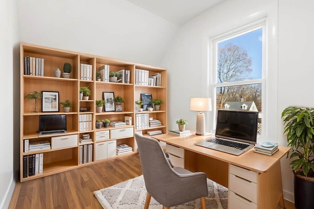 12 Viden Road Quincy, MA 02169 - Photo 7 of 29 a room with furniture a rug and a bookshelf