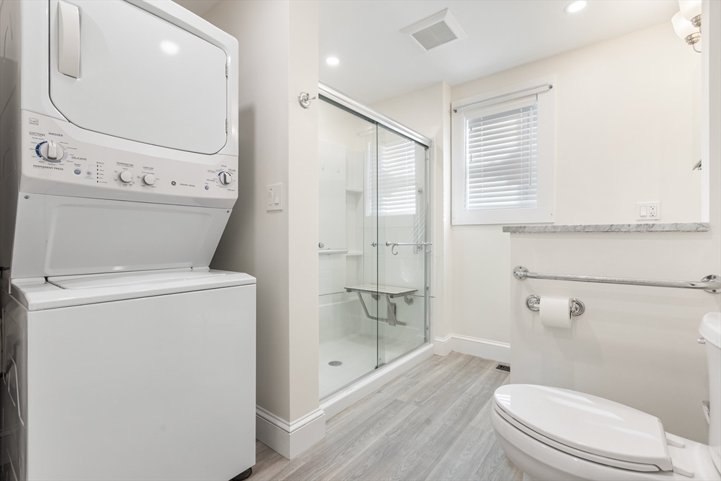 12 Viden Road Quincy, MA 02169 - Photo 8 of 29 a bathroom with a granite countertop toilet a sink and a mirror