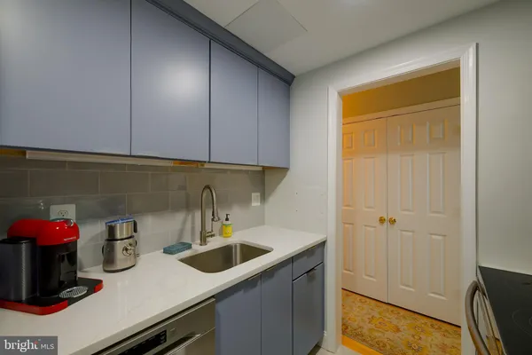 a kitchen with sink and cabinets