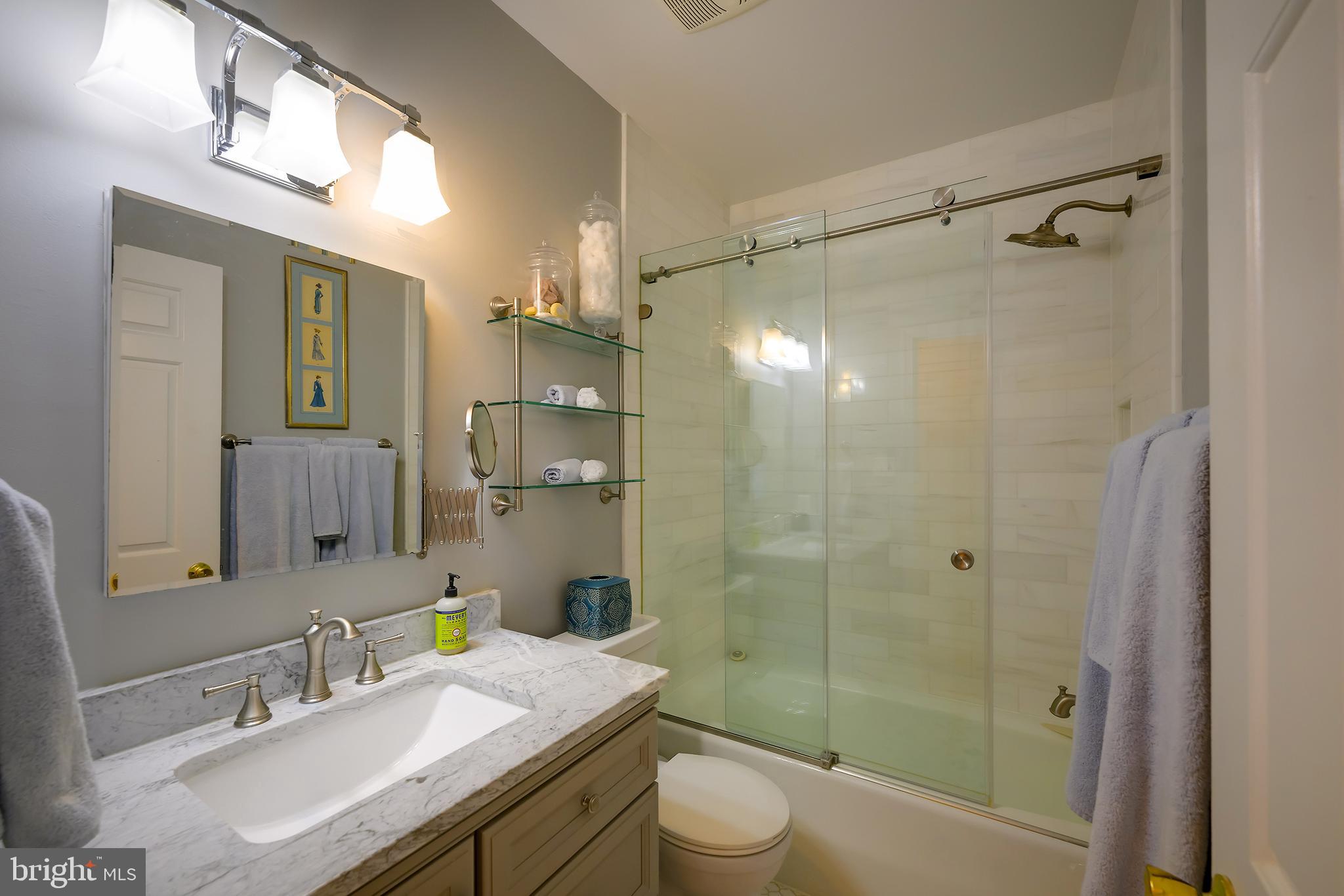 226 3rd Street Northeast, Unit 35 Washington, DC 20002 - Photo 14 of 19 a bathroom with a granite countertop shower sink vanity mirror and toilet