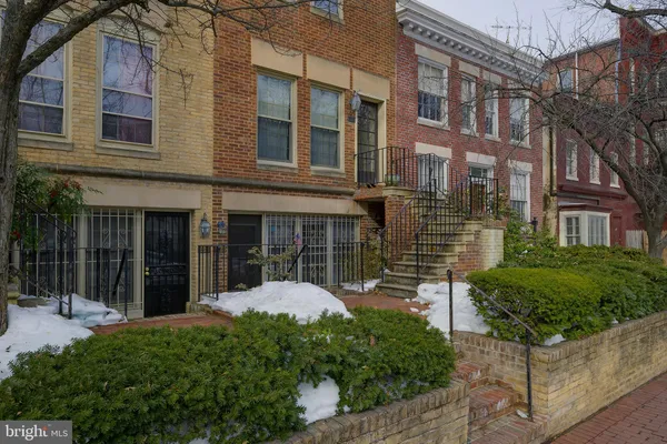 a view of a brick building next to a yard
