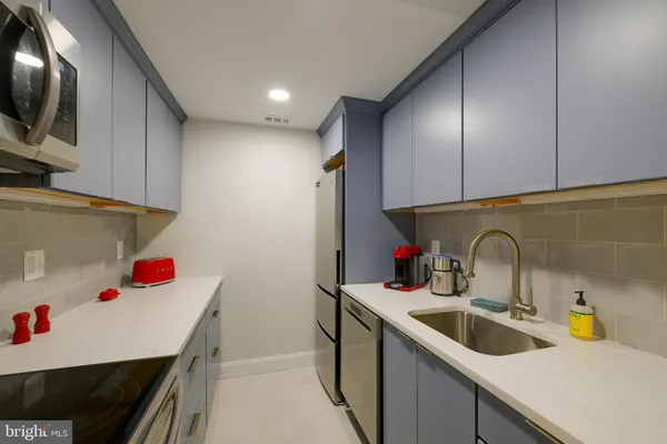 a kitchen with a sink cabinets and appliances