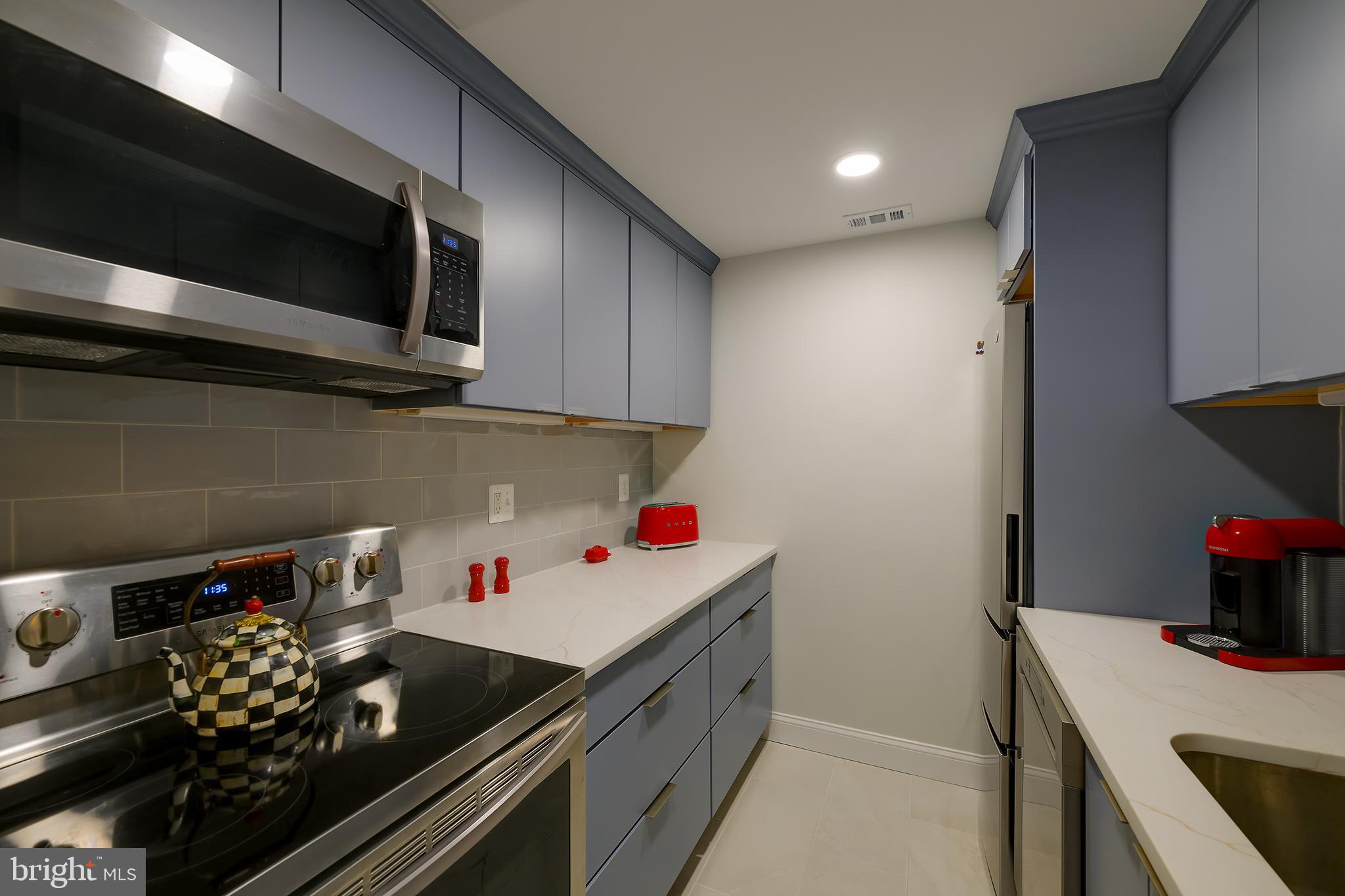226 3rd Street Northeast, Unit 35 Washington, DC 20002 - Photo 9 of 19 a kitchen with a stove and a microwave