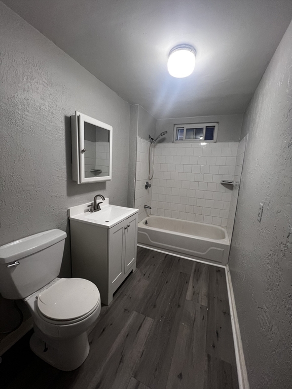55 Vernon Street, Unit 2 Worcester, MA 01610 - Photo 4 of 10 a bathroom with a toilet sink and mirror