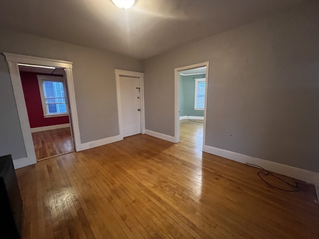 55 Vernon Street, Unit 2 Worcester, MA 01610 - Photo 6 of 10 a view of an empty room with wooden floor and closet