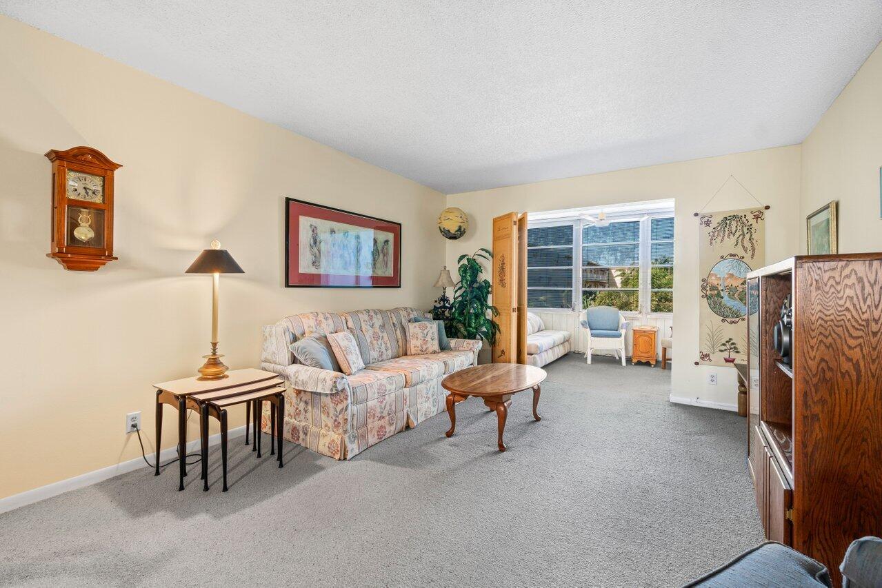 2615 Northeast 3rd Street, Unit 308 Boynton Beach, FL 33435 - Photo 14 of 27 a living room with furniture and a fireplace