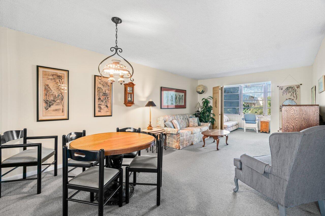 2615 Northeast 3rd Street, Unit 308 Boynton Beach, FL 33435 - Photo 18 of 27 a living room with furniture a dining table and a window