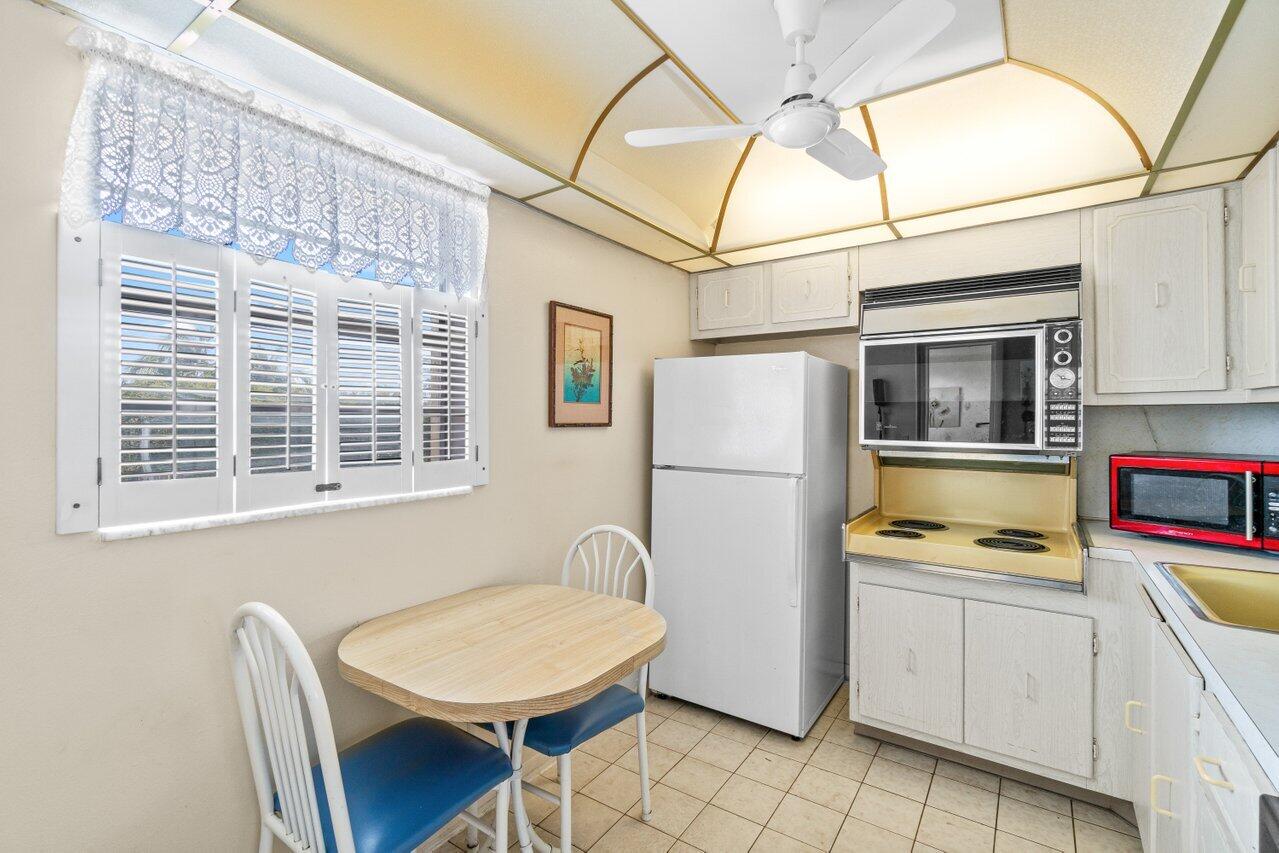 2615 Northeast 3rd Street, Unit 308 Boynton Beach, FL 33435 - Photo 7 of 27 a kitchen with stainless steel appliances a refrigerator and a stove