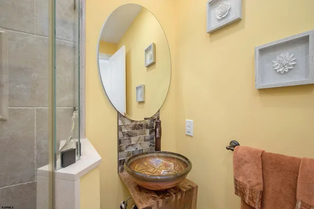 a bathroom with a sink mirror and toilet