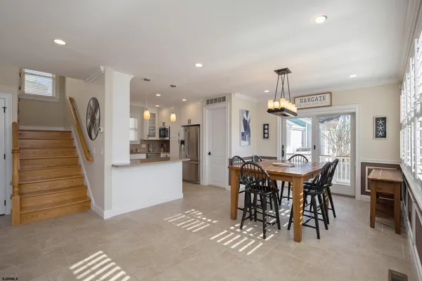 a dining area with furniture and a chandelier