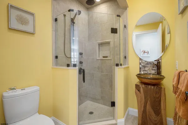 a bathroom with a toilet and a mirror