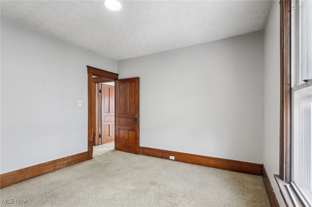 73 East York Street Akron, OH 44310 - Photo 27 of 36 Unfurnished room with light colored carpet and a textured ceiling