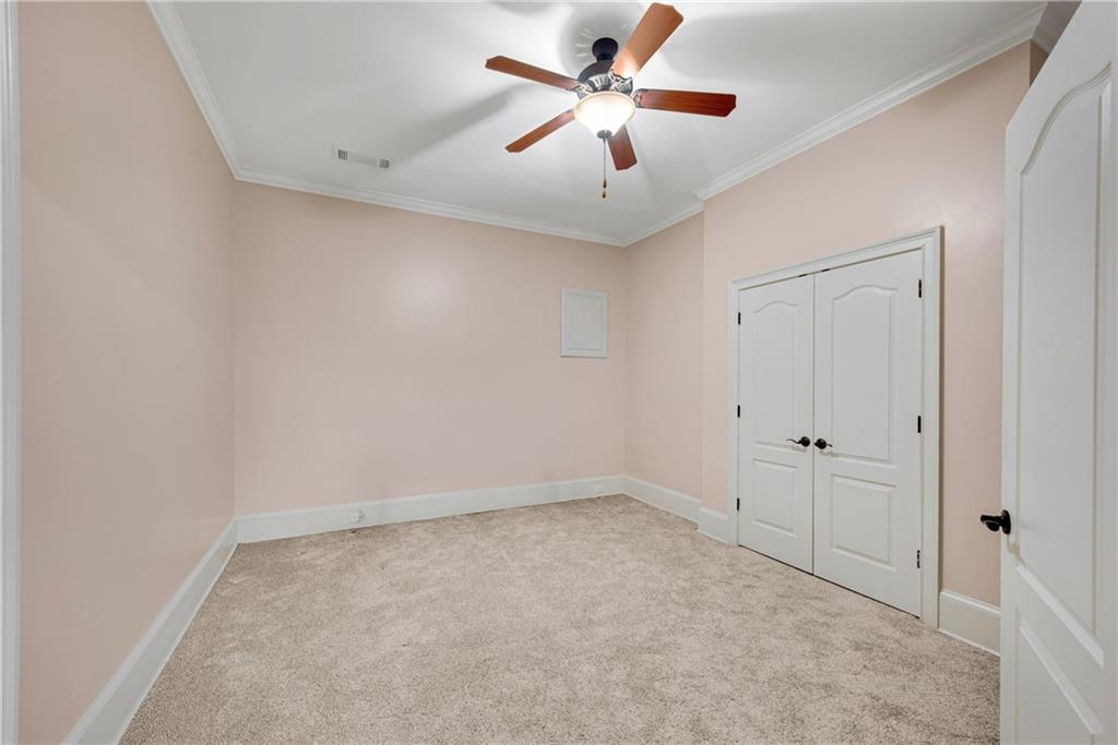 13942 Tree Loft Road Milton, GA 30004 - Photo 69 of 102 an empty room with closet and a chandelier fan