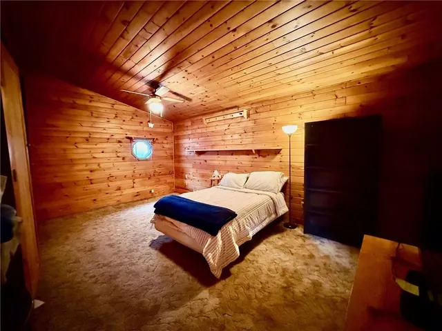 a bedroom with a bed and a night stand