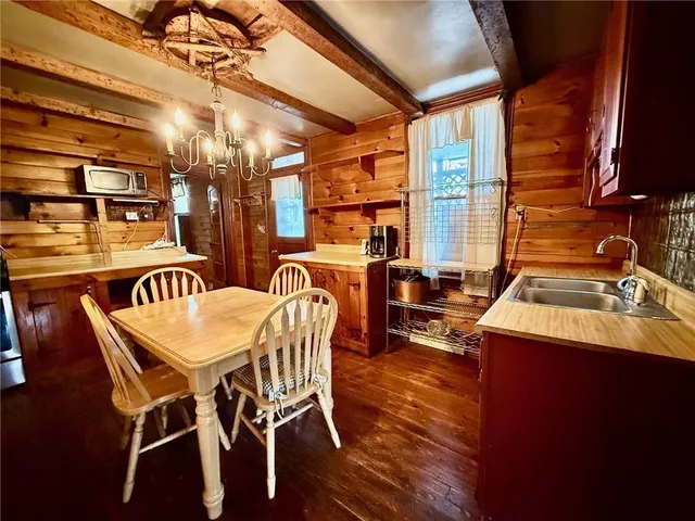 a view of a dining room with furniture and chandelier