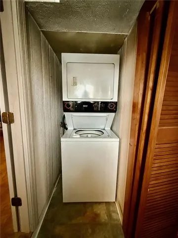 a utility room with wooden floor washer and dryer