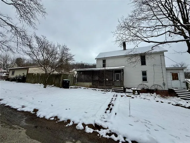 a view of a street with snow on the road