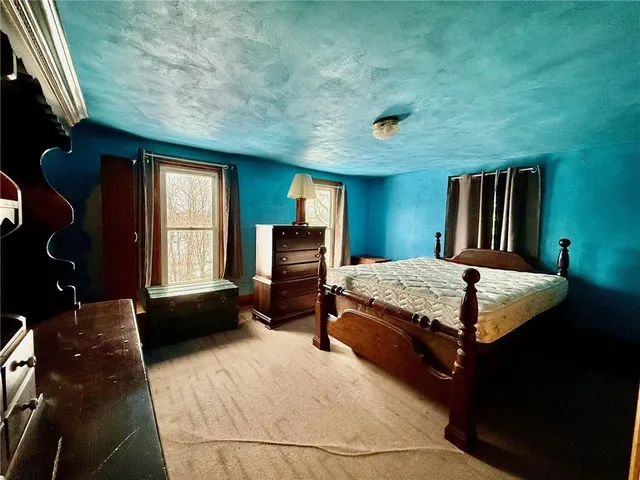 a bedroom with a bed and window